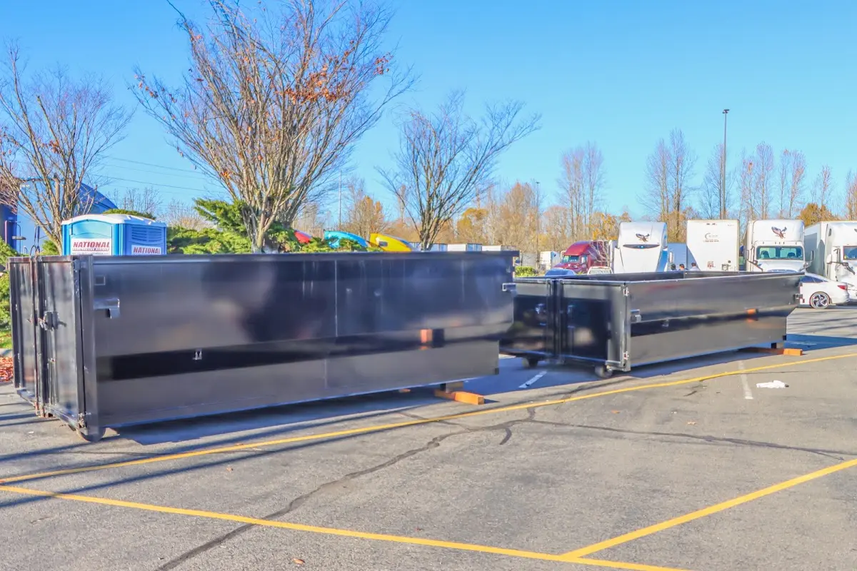 Professional dumpster rental service with roll-off container on residential driveway in Shady Hollow